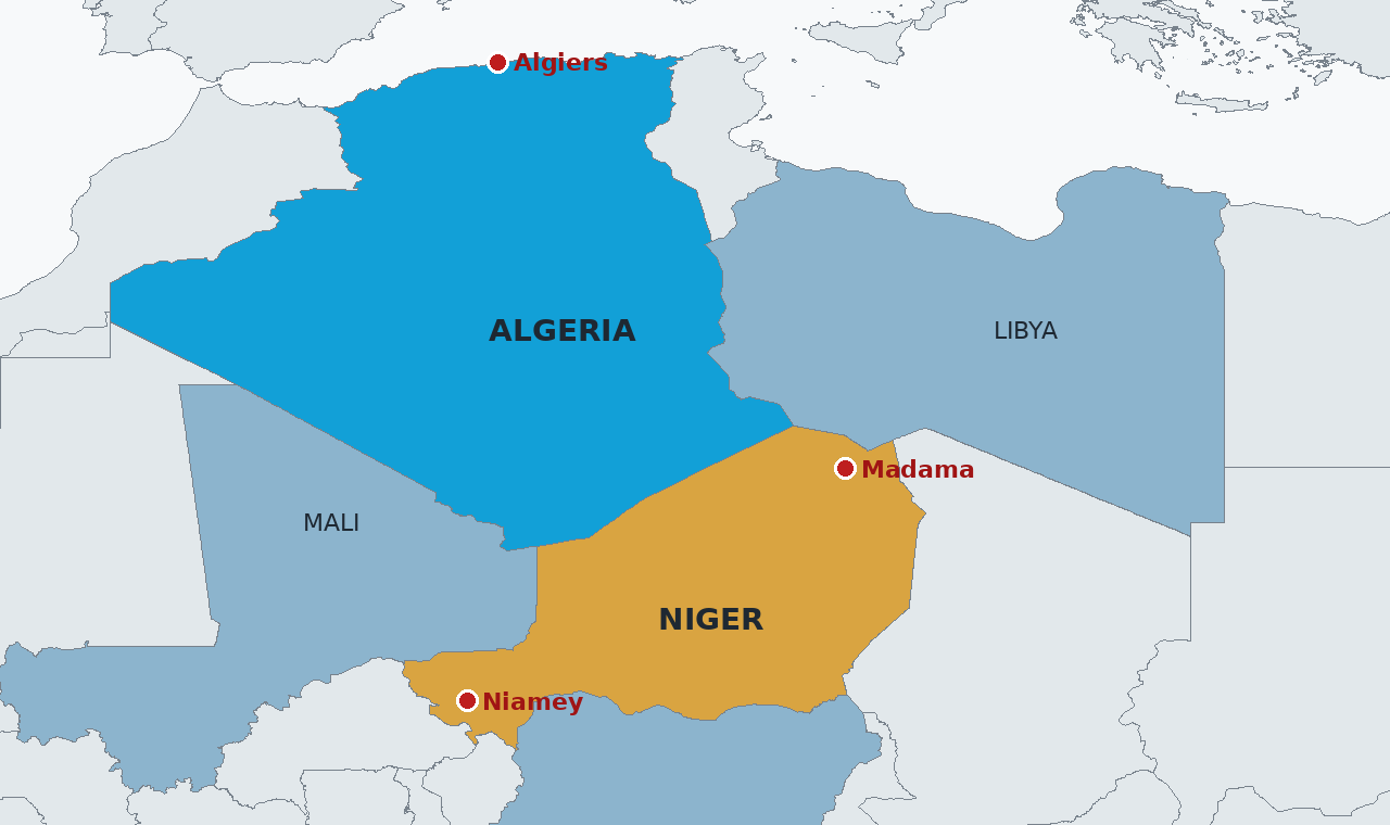 Algeria in blue and Niger in amber, sharing a desert border of about 960 kilometres, with Algiers, Niamey and Madama, the reported deployment site in Niger's north, marked.