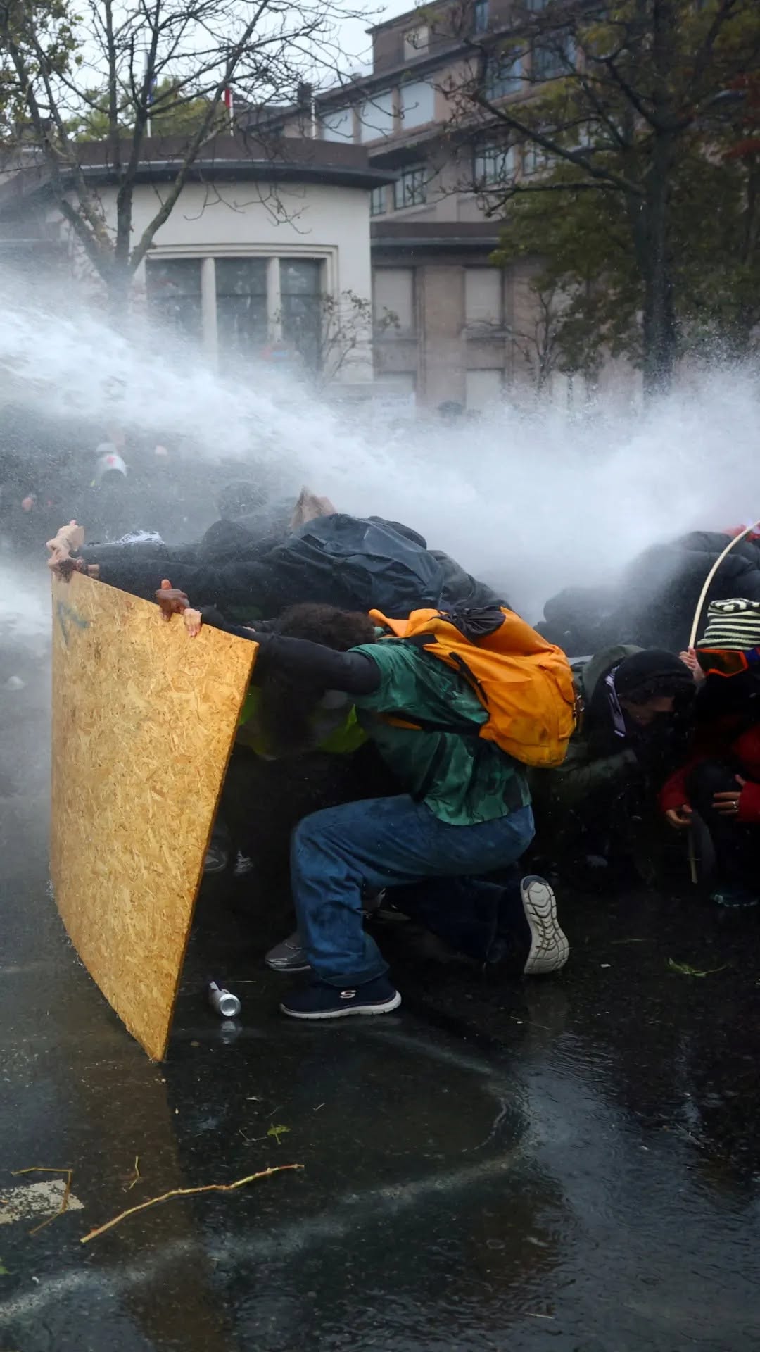 Protesters shield themselves from a water cannon during the European youth protest wave that began with French school pupils in September 2026 and spread across the continent. France is the centre of the movement. File photo.