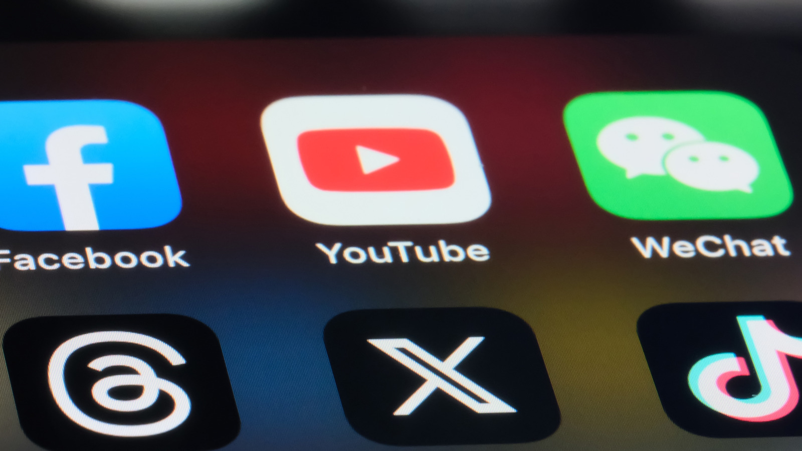 Social media app icons on a phone screen. Greece's law covers social networking services and leaves private messaging and educational use outside it. File photo.