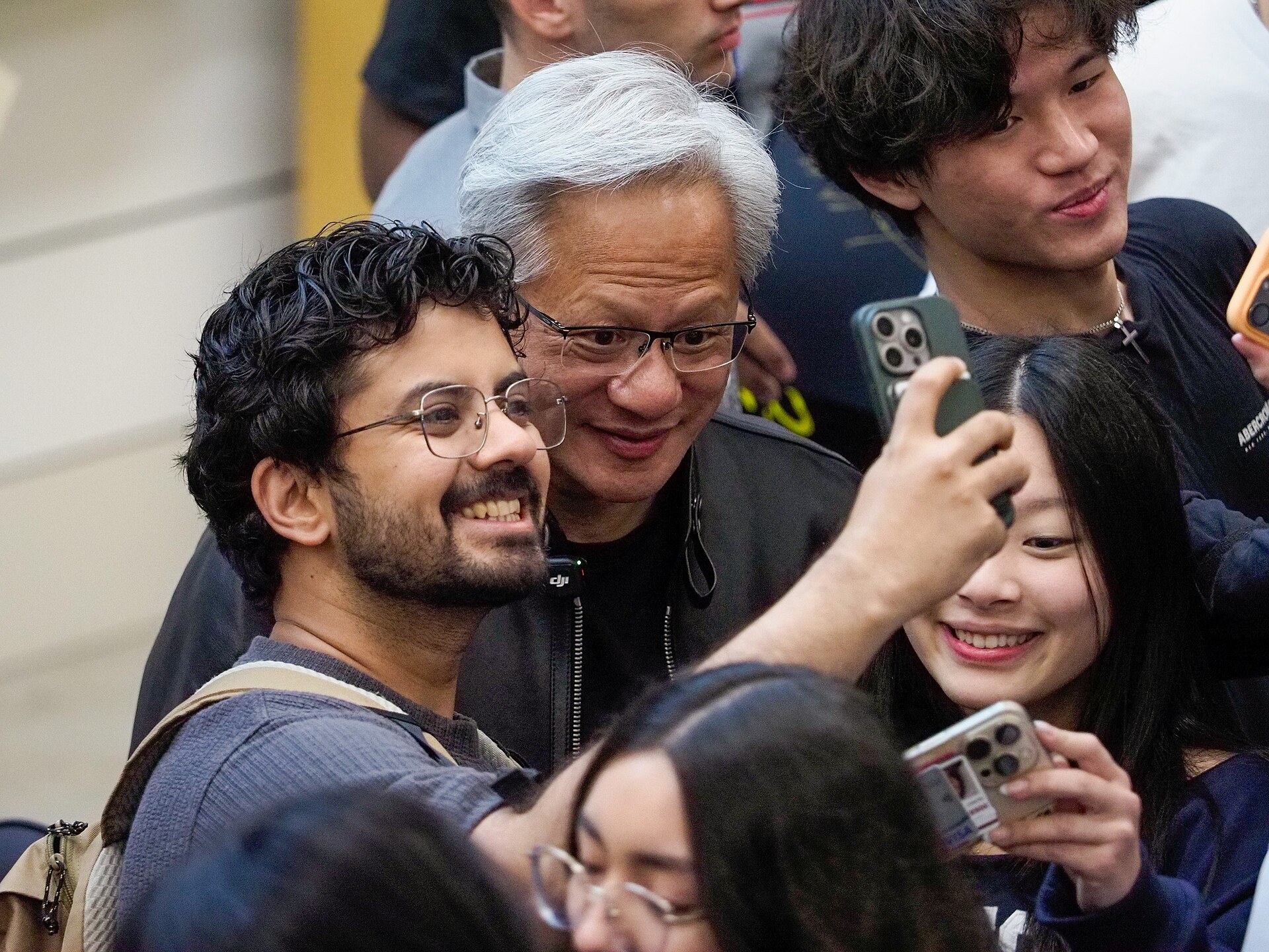Nvidia chief executive Jensen Huang poses for a selfie with students at Stanford University in April 2026.