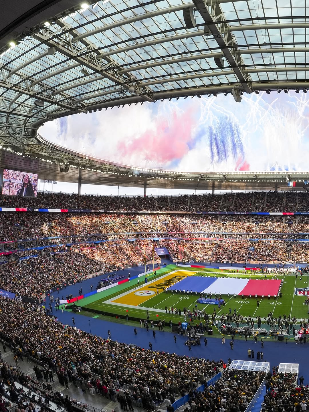 The Stade de France packed before kickoff, the French flag spread across the field, for the first NFL regular season game played in France.